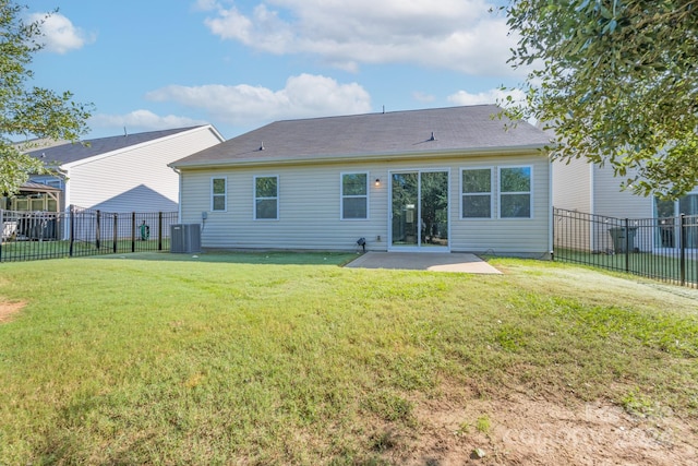 rear view of property with cooling unit, a patio area, and a yard