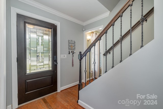 foyer featuring ornamental molding and hardwood / wood-style flooring