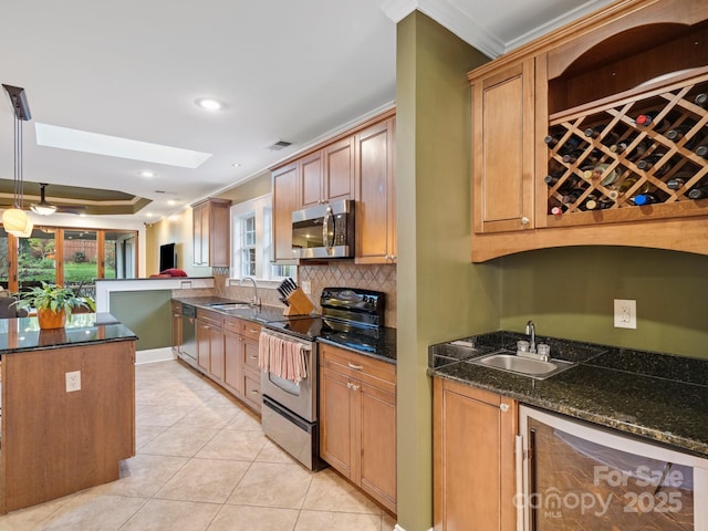 kitchen with backsplash, ornamental molding, dark stone counters, and appliances with stainless steel finishes