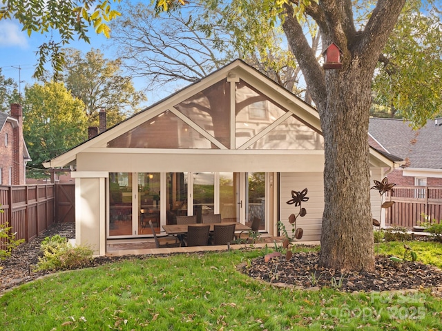 back of house featuring a lawn