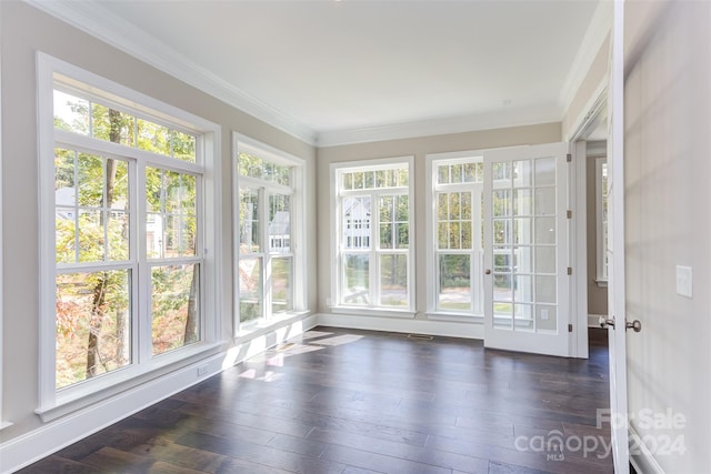 unfurnished sunroom featuring plenty of natural light, ornamental molding, and hardwood / wood-style flooring