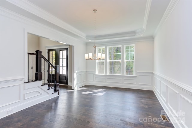 unfurnished dining area with an inviting chandelier, crown molding, dark hardwood / wood-style flooring, and a tray ceiling