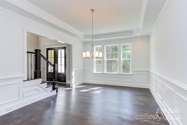 unfurnished dining area with plenty of natural light, a chandelier, stairway, and dark wood-style floors