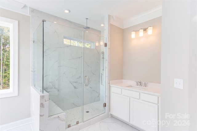 bathroom featuring ornamental molding, a shower with shower door, and vanity