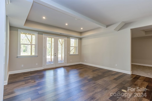 spare room with french doors and dark hardwood / wood-style flooring