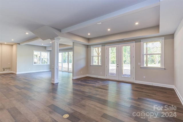 unfurnished living room with plenty of natural light, french doors, and dark hardwood / wood-style flooring