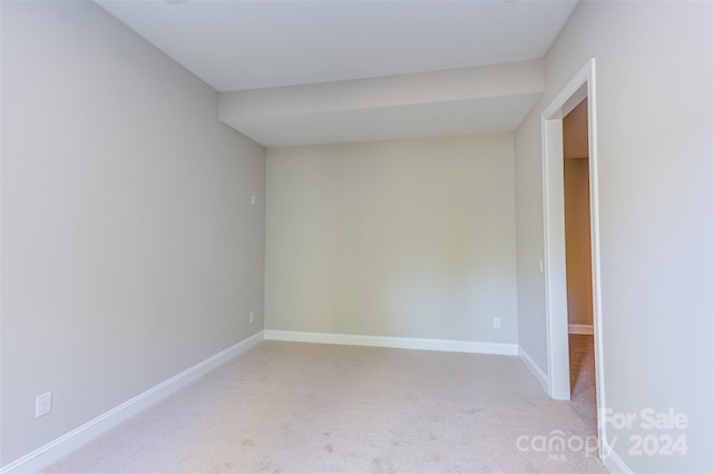 unfurnished room with light carpet