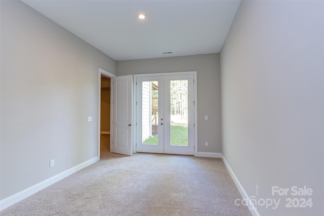 carpeted spare room featuring baseboards, french doors, recessed lighting, and visible vents