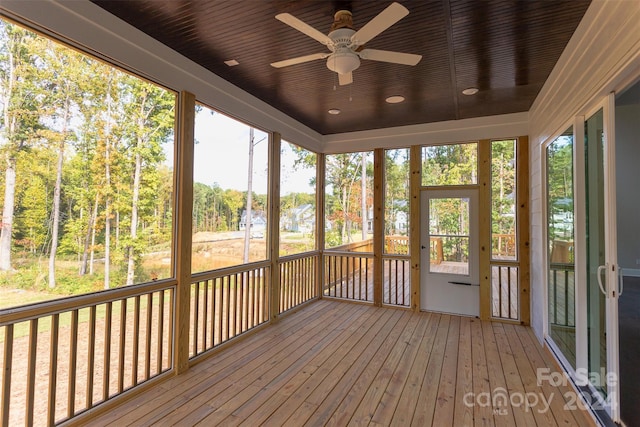 unfurnished sunroom with ceiling fan