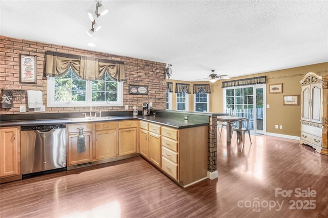 kitchen with ceiling fan, dishwasher, sink, and kitchen peninsula