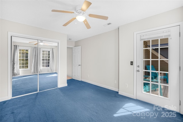 carpeted empty room with ceiling fan