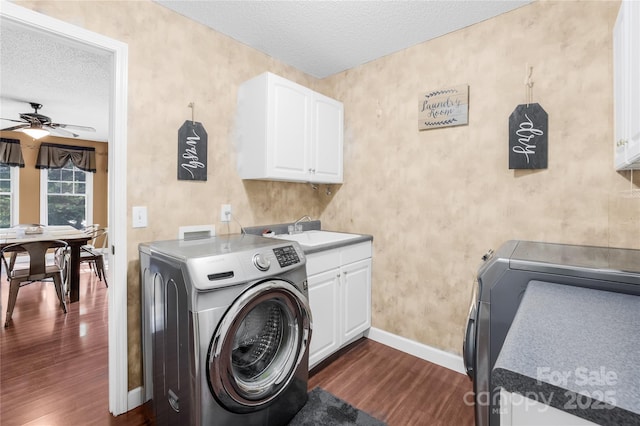 clothes washing area with dark wood-type flooring, sink, cabinets, a textured ceiling, and ceiling fan