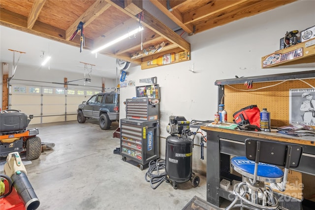 garage with a garage door opener and a workshop area