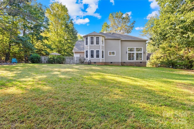 back of property featuring a lawn