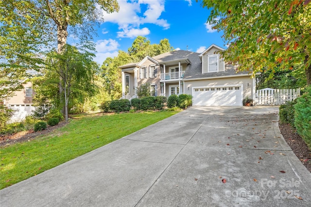 view of front property with a balcony, a garage, and a front lawn