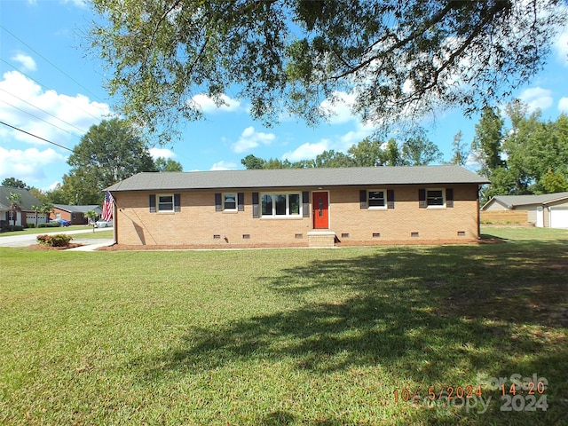 ranch-style home with a front yard and a garage