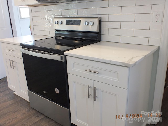 kitchen with decorative backsplash, dark hardwood / wood-style floors, stainless steel electric range, and white cabinets