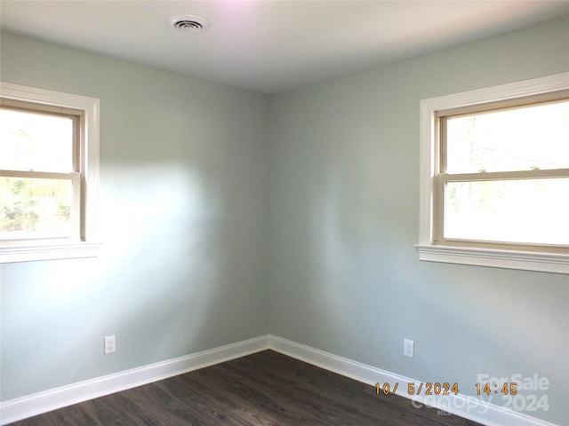 unfurnished room featuring dark hardwood / wood-style flooring