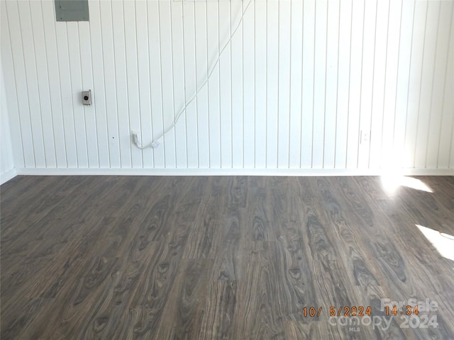 room details featuring wooden walls and hardwood / wood-style floors