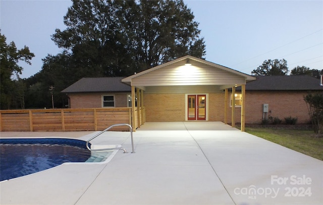 view of pool featuring french doors and a patio area