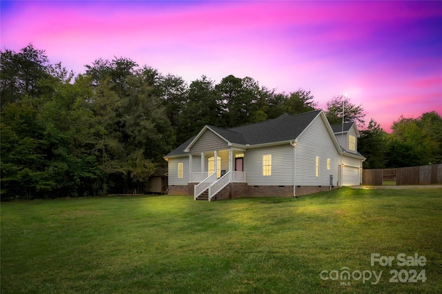 view of front of home featuring a yard and a garage