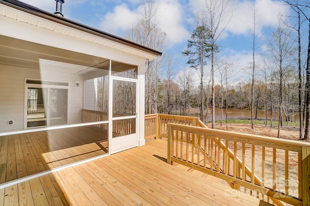 deck with a water view and a sunroom