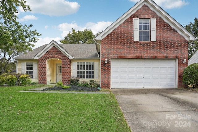 front of property featuring a garage and a front lawn