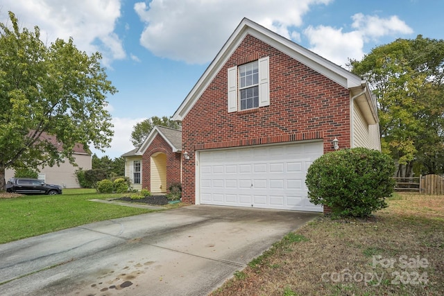 view of property with a front yard and a garage