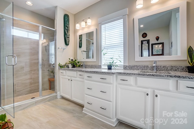 bathroom with an enclosed shower and vanity