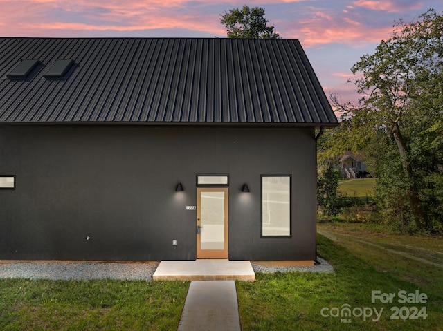 back house at dusk with a yard