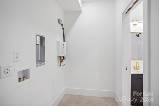 laundry room with electric panel, washer hookup, and sink