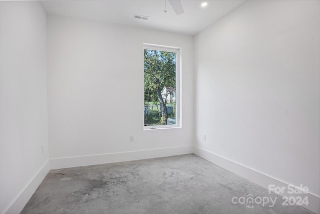 empty room with concrete flooring and ceiling fan