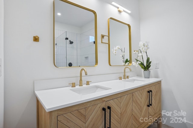 bathroom with vanity and tiled shower