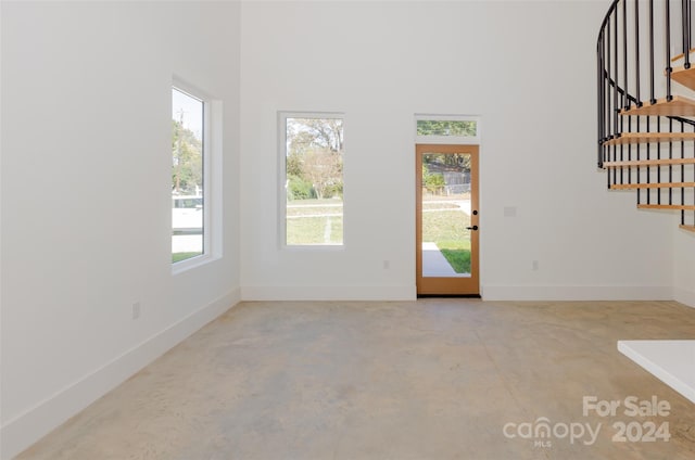 spare room featuring concrete flooring and a wealth of natural light