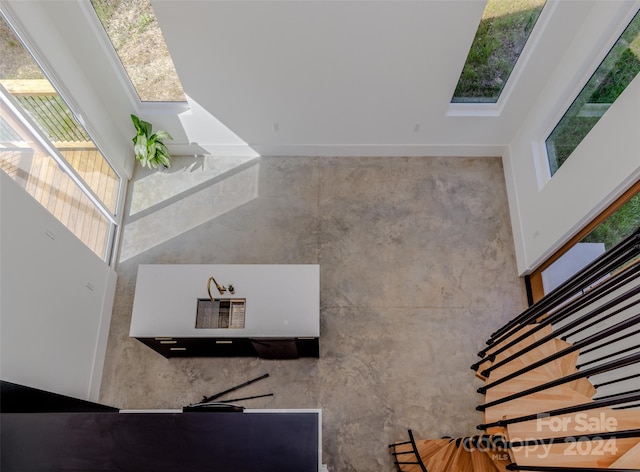 stairway with a wealth of natural light and a high ceiling