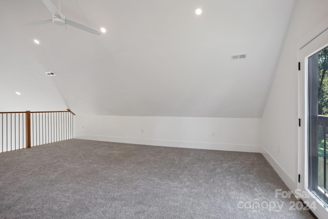 additional living space with carpet floors, ceiling fan, and vaulted ceiling