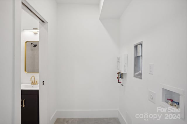 laundry area featuring hookup for a washing machine, sink, and hookup for an electric dryer