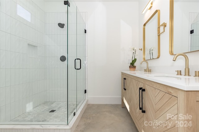 bathroom featuring a shower with shower door, vanity, and concrete floors