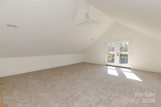 additional living space with french doors, light colored carpet, lofted ceiling, and ceiling fan