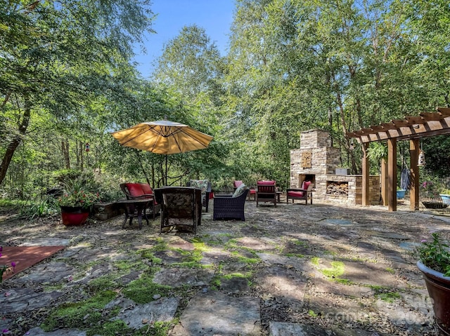 view of patio with an outdoor stone fireplace