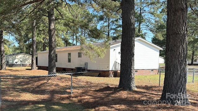 view of side of property featuring crawl space and fence private yard