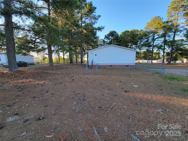 view of yard featuring an outdoor structure and fence