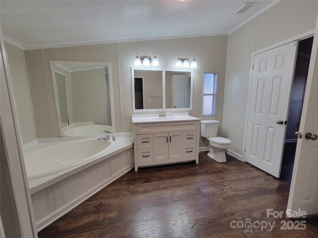 full bathroom featuring vanity, toilet, visible vents, a garden tub, and wood finished floors