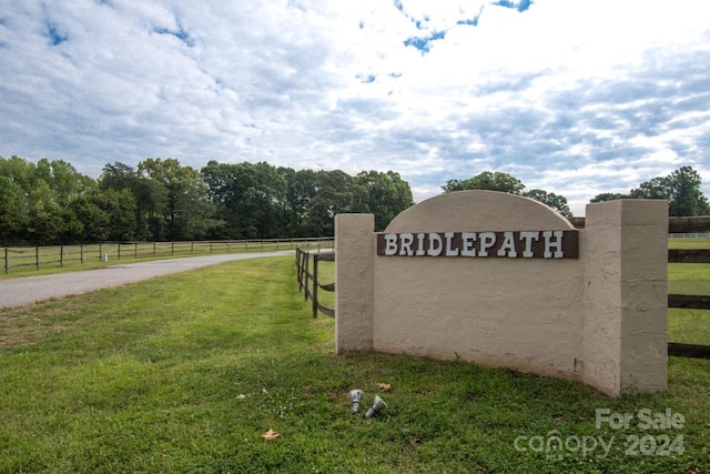 community sign with a rural view and a lawn