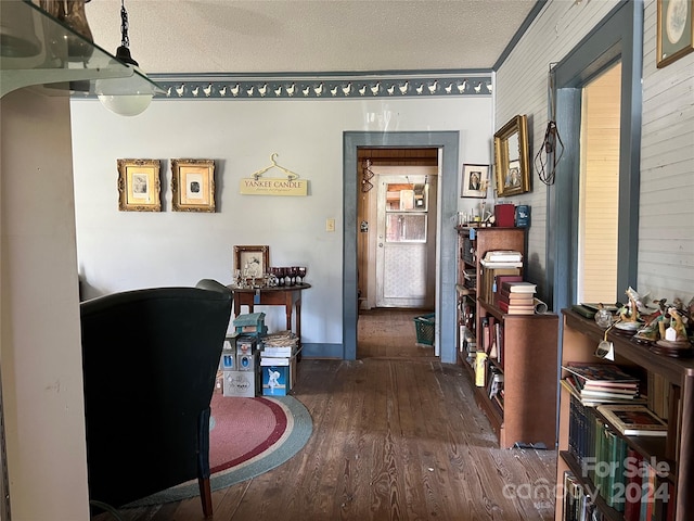 hallway with crown molding, dark hardwood / wood-style floors, and a textured ceiling