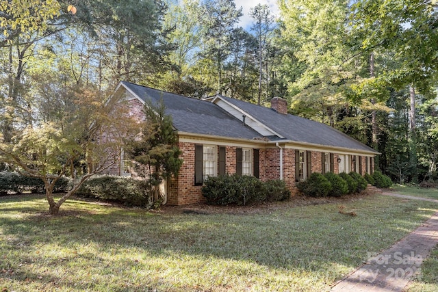 view of side of property with a yard