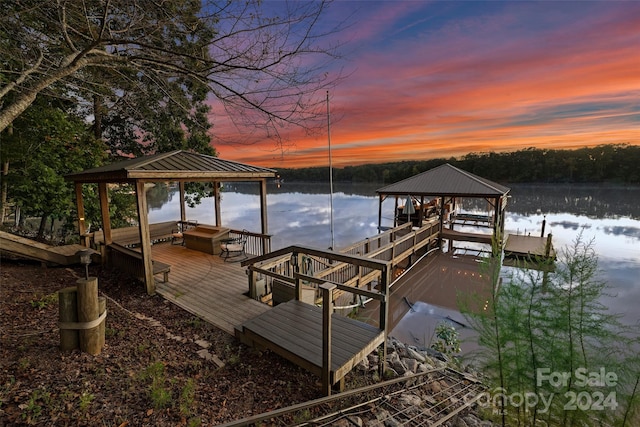 view of dock with a gazebo and a water view