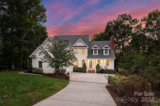 view of front of home with a yard and a porch