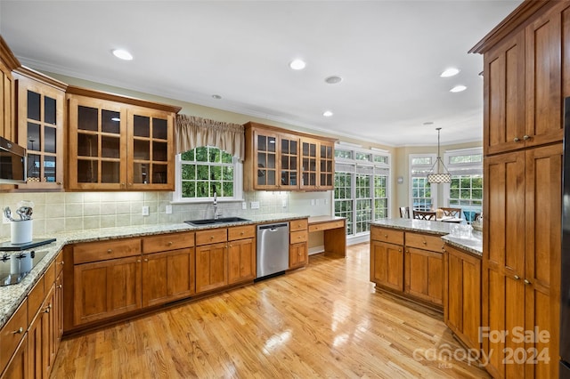 kitchen with pendant lighting, light wood-type flooring, dishwasher, and sink