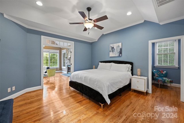 bedroom with ornamental molding, light hardwood / wood-style floors, vaulted ceiling, and ceiling fan